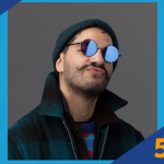 Man in sunglasses and beanie making a pouty expression.