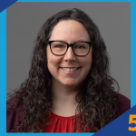 Smiling woman with long curly hair and glasses wearing a red top and maroon cardigan, next to SUNY Empire 5 Minute Feature logo.
