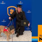 A photo of Mariela Lombard posing with her dog at graduation