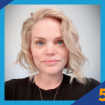 Headshot of Lauren Allen with short, wavy blonde hair and light skin, looking at the camera with a neutral expression, wearing a black top and a thin necklace against a light gray background. The image is framed by a blue graphic with a torch logo in the top left and the text “5 Minute Feature” in the bottom right.