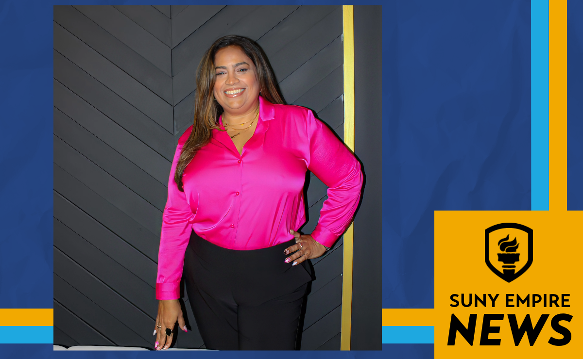 Photo of Tayrin Tapia smiling in a bright pink blouse and black pants, with SUNY Empire News branding.