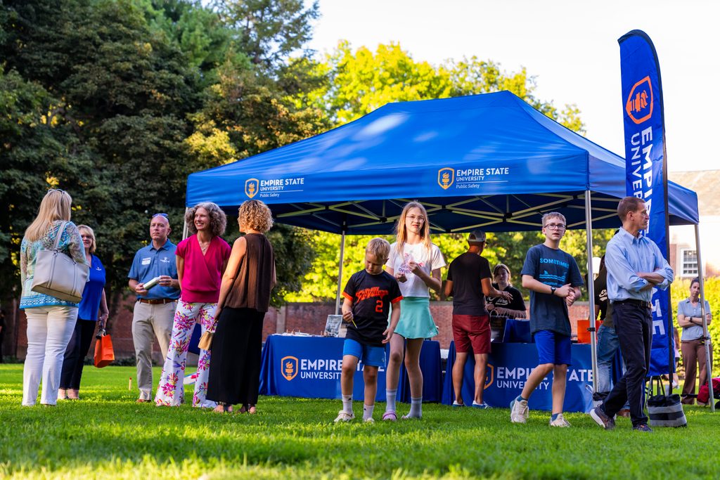 people congregated in front of a blue tent